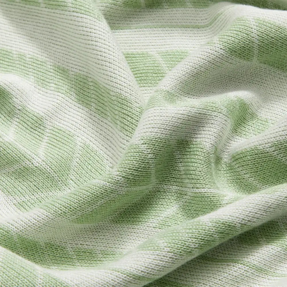 Soft light green and white striped bamboo knitted cooling blanket with subtle textured weave for bedroom decorbites use