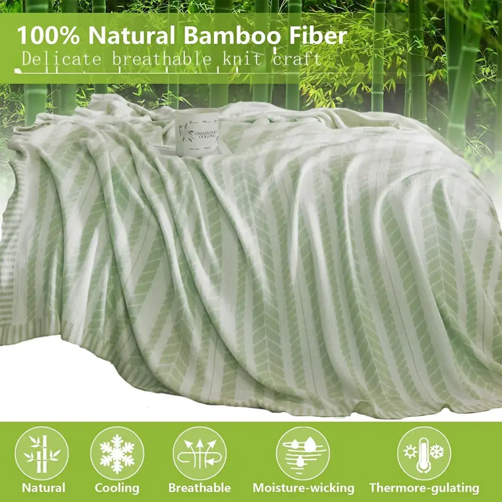 A soft light green decorbites bamboo knitted cooling blanket with a subtle leaf pattern for bedroom use