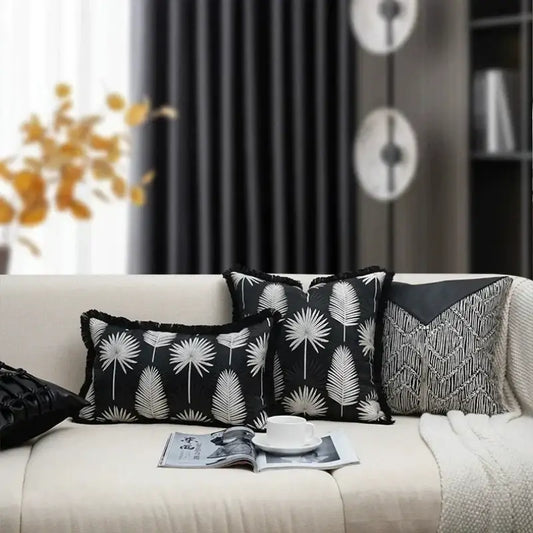 Black pillow cover with white palm leaf pattern and frayed edges for light luxury designer living room decor