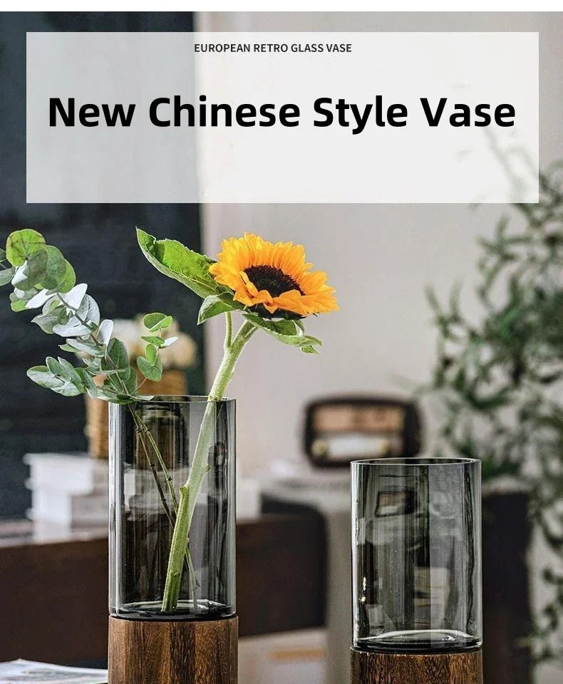 Clear glass vase with wooden base in european retro design holding a sunflower for living room table decoration
