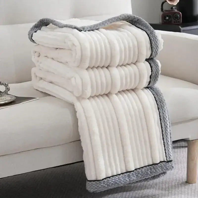 A cream and gray ribbed fleece luxury sofa blanket by decorbites light luxury ideal for elegant living room decor