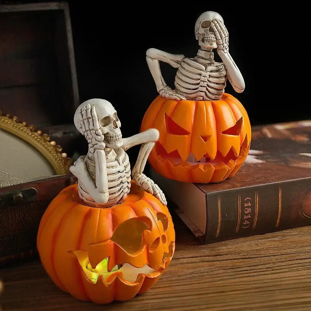 Lighted skull pumpkin skeleton sculpture set with orange carved pumpkin lanterns and white skeleton figurines for living room decor