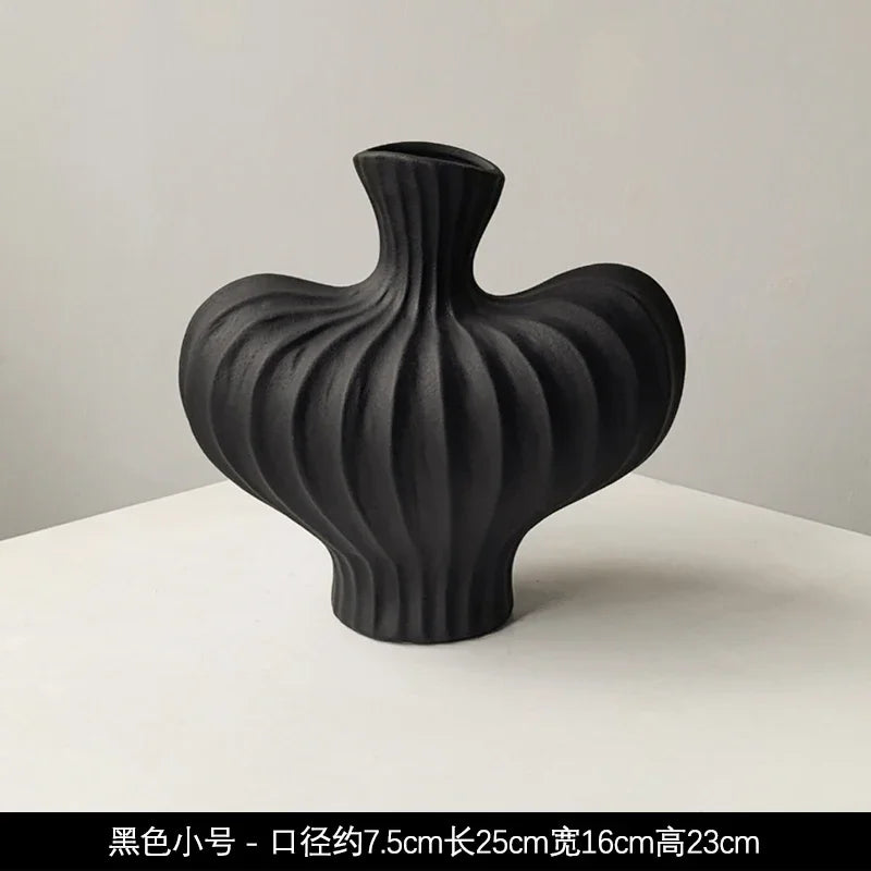 Black ceramic Livetai wabi-sabi vase with sleek ribbed design and asymmetrical shape for modern boho decor