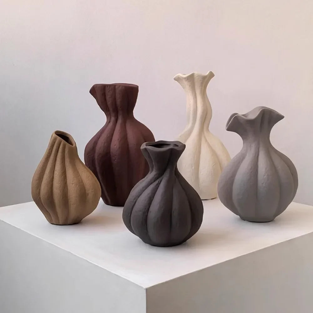 A collection of five livetai wabi-sabi handmade ceramic vases in earthy tones with unique sculpted forms and matte finish