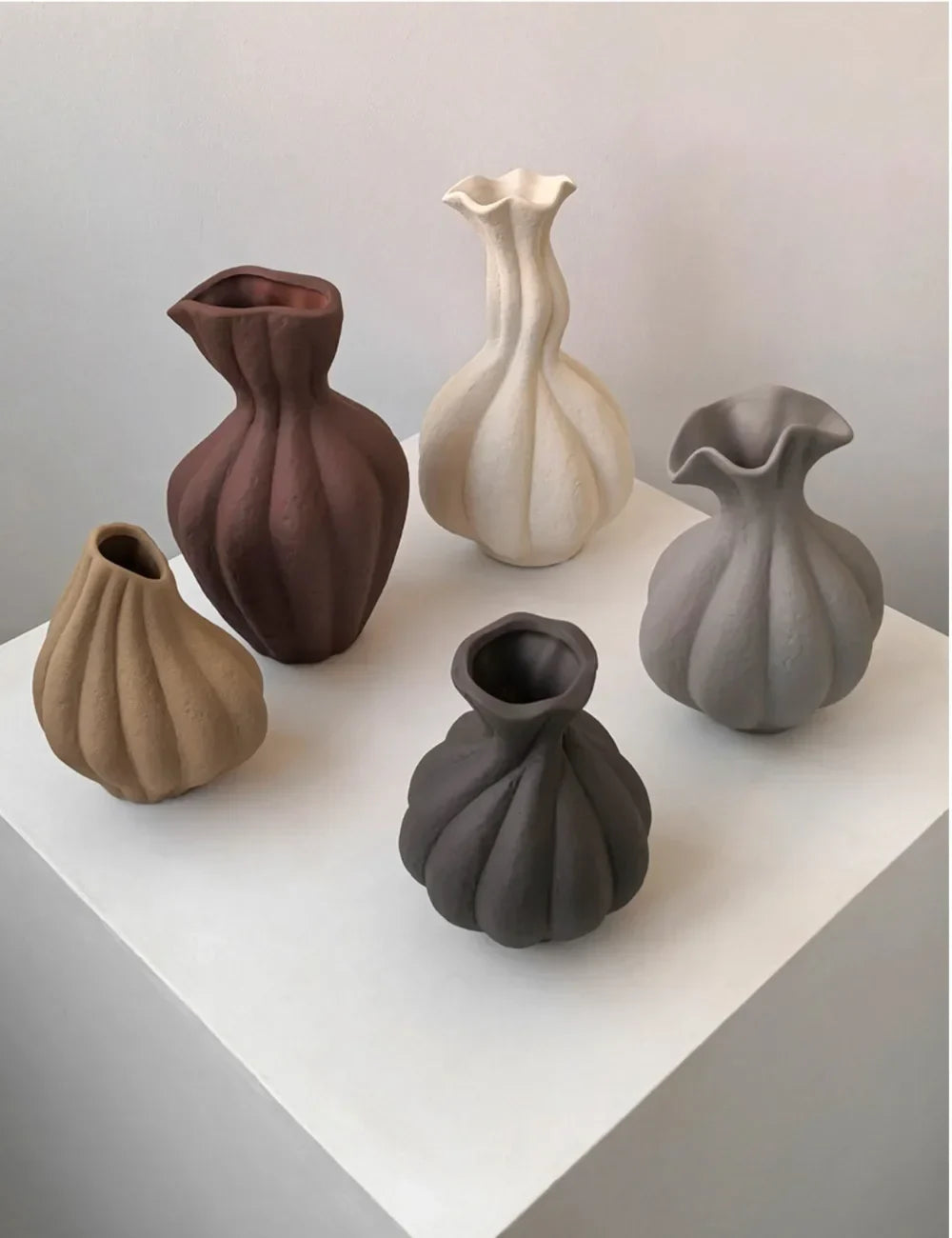 A collection of five livetai wabi-sabi handmade ceramic vases in earthy tones with ribbed organic sculptural shapes for modern boho decor