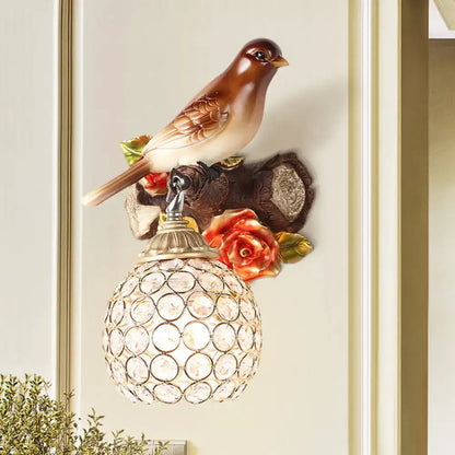 Lodge brown and cream bird wall sconce with orange roses and crystal global shade for bedroom lighting