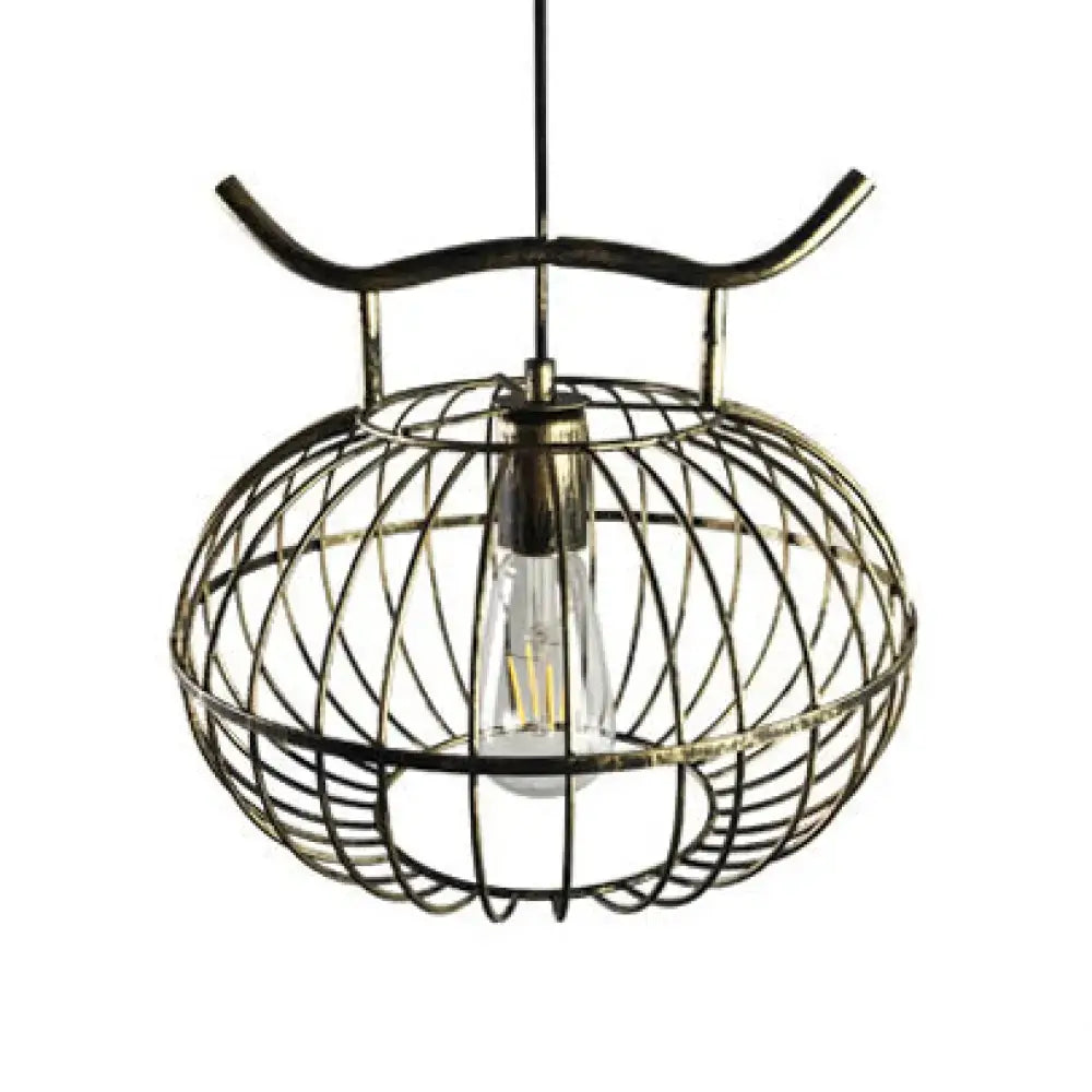 Antique brass cage-style pendant light with a visible Edison bulb in rust aged brass lantern design by DecorBites™