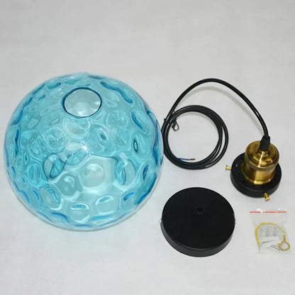 Loft blue glass pendant light with textured blue glass globe, brass hardware, and black cord for kitchen decorbites loft blue decor