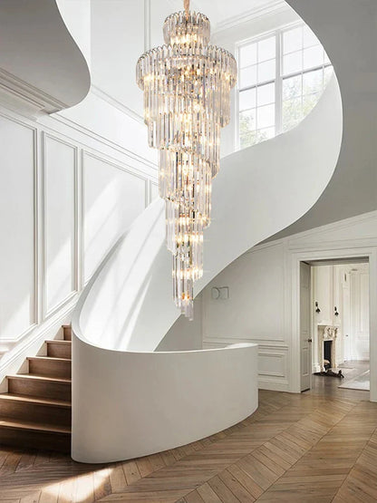 A long crystal staircase gold chandelier with cascading clear glass tiers and a central brass fixture for hotel hall decor