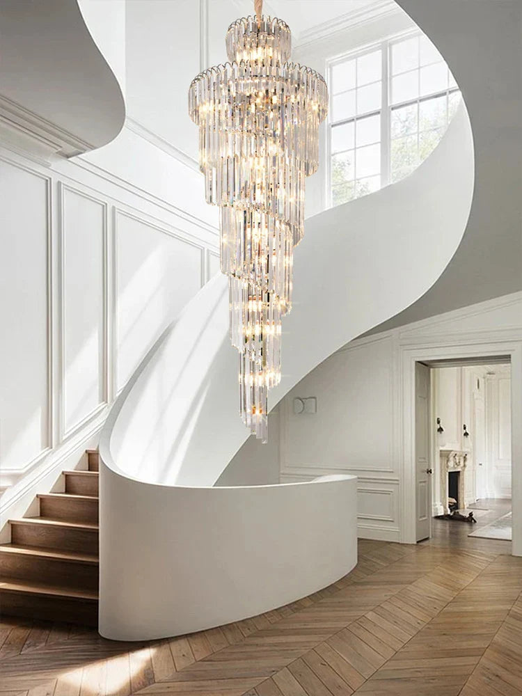 A long crystal staircase gold chandelier with cascading clear glass tiers and a central brass fixture for hotel hall decor