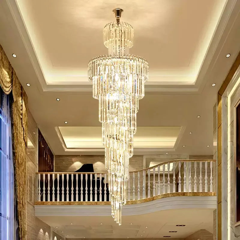 A multi-tiered crystal staircase gold chandelier with clear glass prisms for hotel hall and luxury villa decor