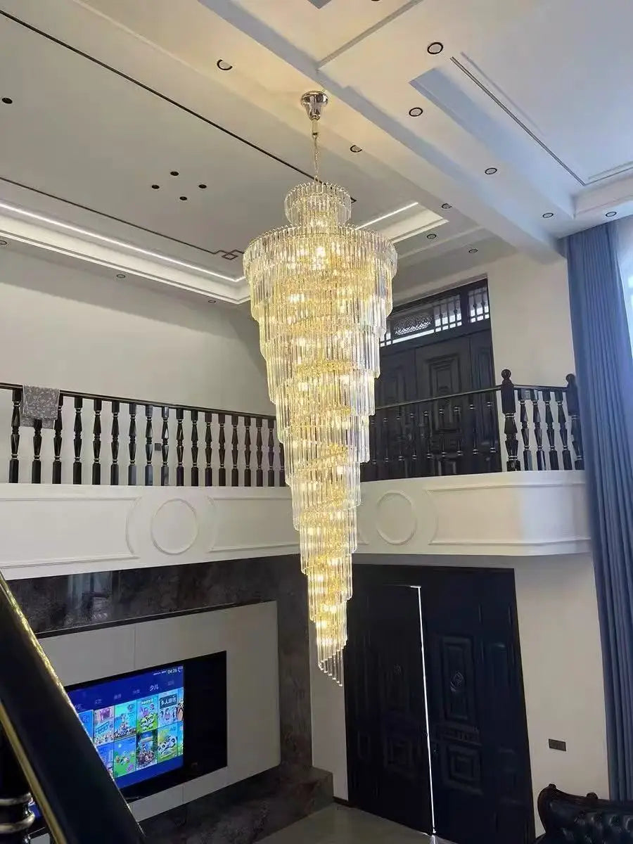 A long crystal staircase gold chandelier with cascading clear and amber crystals for hotel hall or villa decor