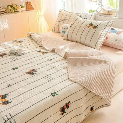 Cream-colored quilted cotton mattress mat with decorbites cartoon pattern featuring dachshund prints and black stripes