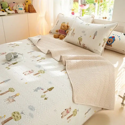 Cream-colored quilted mattress mat with decorbites cartoon pattern cotton featuring whimsical deer and trees design