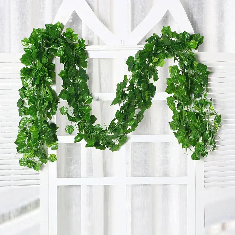 A lush green silk creeper plant with detailed leaves and vines draped over a white lattice for decorbites green silk decor