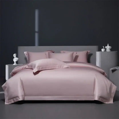 A soft blush pink satin bedding set with matching pillows contrasts with luxe burgundy red egyptian cotton style