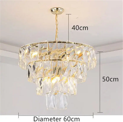 A luxe gold steel crystal pendant light chandelier with multi-tiered faceted glass and gold-toned metal accents
