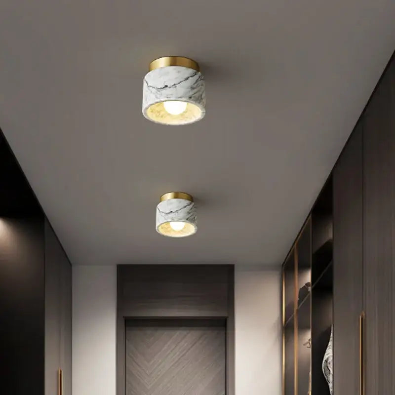 Two modern marble downlight ceiling lights with white green marble shades and gold-toned fixtures for living room decorbites green white