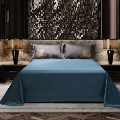 A sleek solid blue satin bedspread with a glossy finish complements a luxurious 1500tc egyptian cotton jacquard bedding set