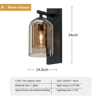 A sleek black iron and cognac glass wall art light with an exposed filament bulb for luxury bedroom decor