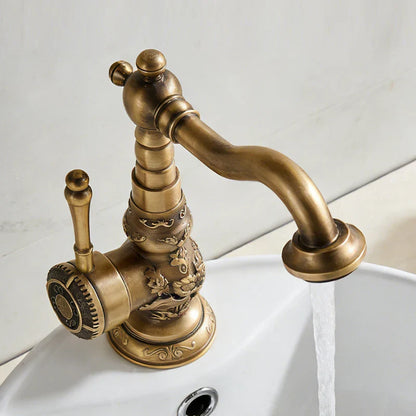Antique bronze copper deck mounted bathroom faucet with single hole lever handle and ornate floral scrollwork for cold water control