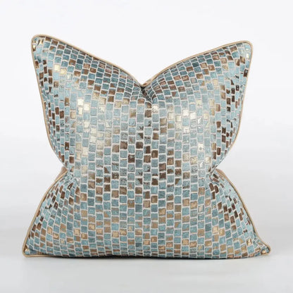 A luxury black and gold geometric decorbites jacquard cushion cover featuring a light blue and metallic gold mosaic pattern with beige border