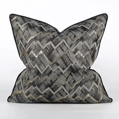 A luxury black and gold geometric jacquard cushion cover with bold zigzag pattern in gray black and metallic gold thread by decorbites jacquard high-end