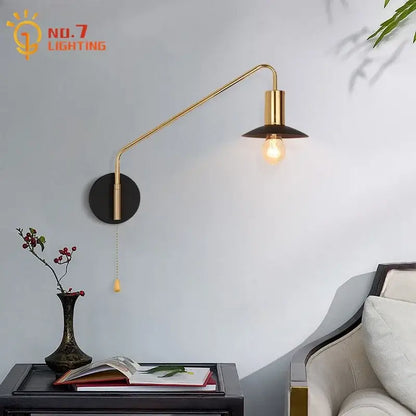 Luxury black and gold swing arm wall lamp with black circular base and exposed bulb for bedroom reading decorbites black gold