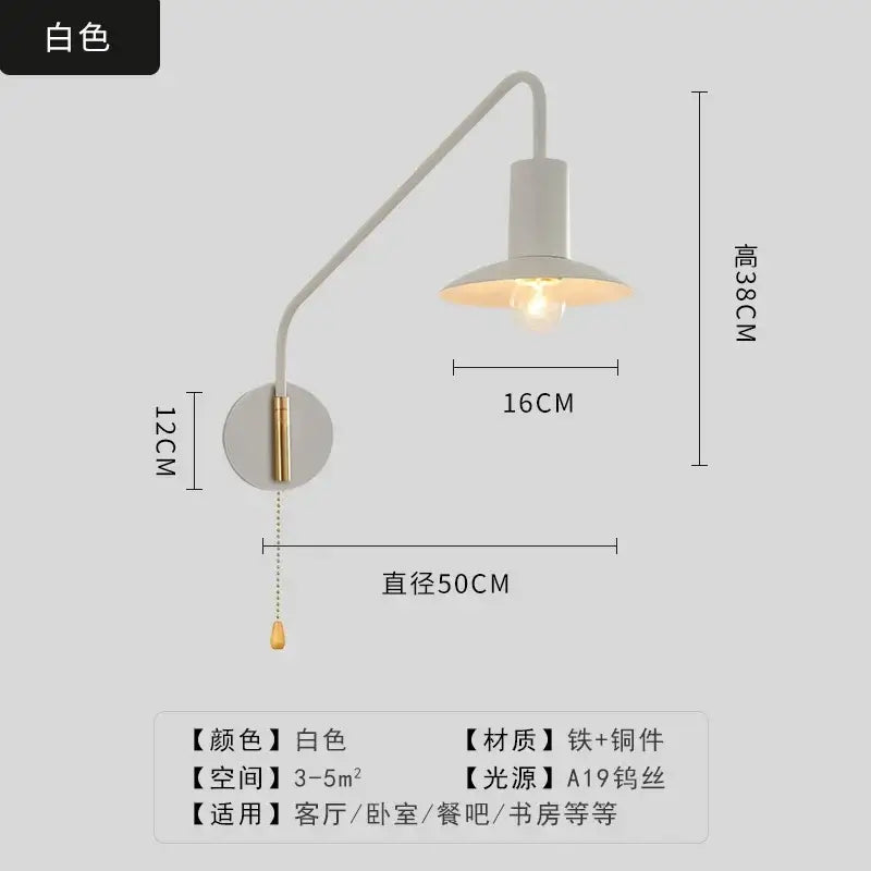 White wall lamp with curved brass swing arm and a19 bulb in decorbites black gold luxury bedroom reading light design