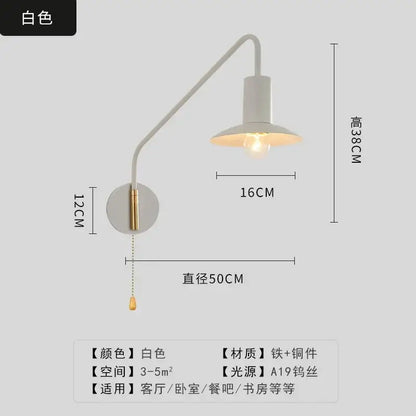 White wall lamp with curved brass swing arm and a19 bulb in decorbites black gold luxury bedroom reading light design