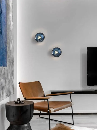 Two circular luxury blue crystal glass wall lamps with textured reflective surface decorbites blue crystal bedroom sconce