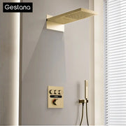 Luxury brushed gold digital rainfall shower system with gold-finished rectangular showerhead and matching control panel and handheld shower
