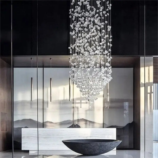 Luxury cascading crystal led chandelier with clear faceted glass pieces suspended on thin metallic wires decorbites crystal led
