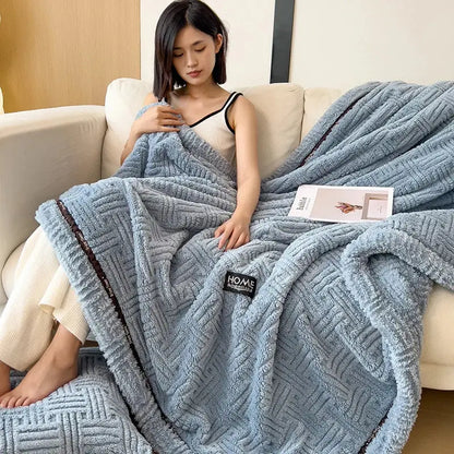 Luxury coral fleece textured light blue plush throw blanket with dark brown trim ideal for winter bedroom use