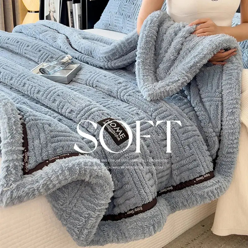 Light blue luxury coral fleece winter blanket with textured woven pattern and brown trim for bedroom use
