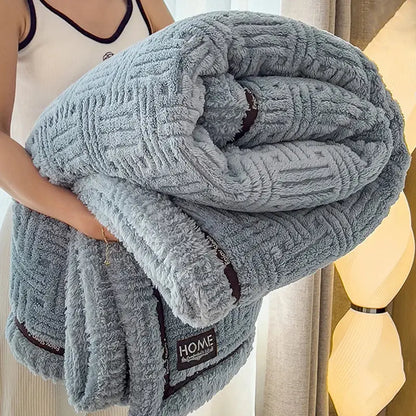 Luxury coral fleece winter blanket in light gray with textured woven pattern and dark brown trim for bedroom use