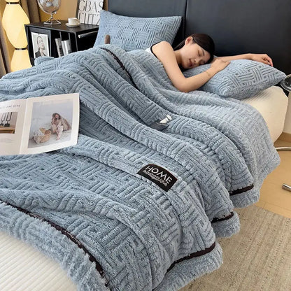 Luxury coral fleece gray winter blanket with soft blue plush woven texture and black trim for bedroom use