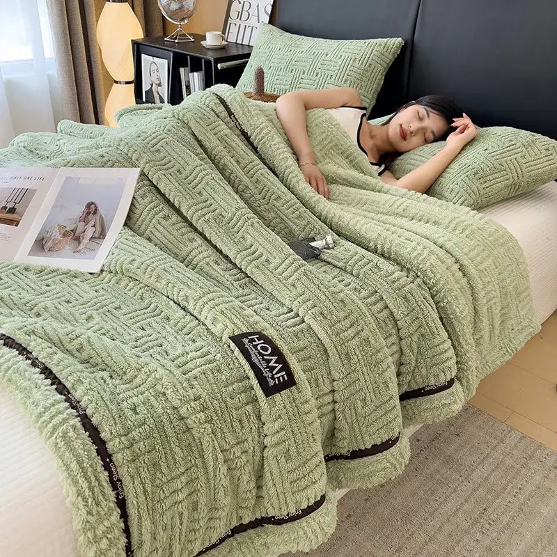 Soft mint green luxury coral fleece throw blanket with textured woven pattern and black trim accents for winter use