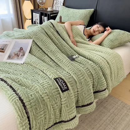 Soft mint green luxury coral fleece throw blanket with textured woven pattern and black trim accents for winter use