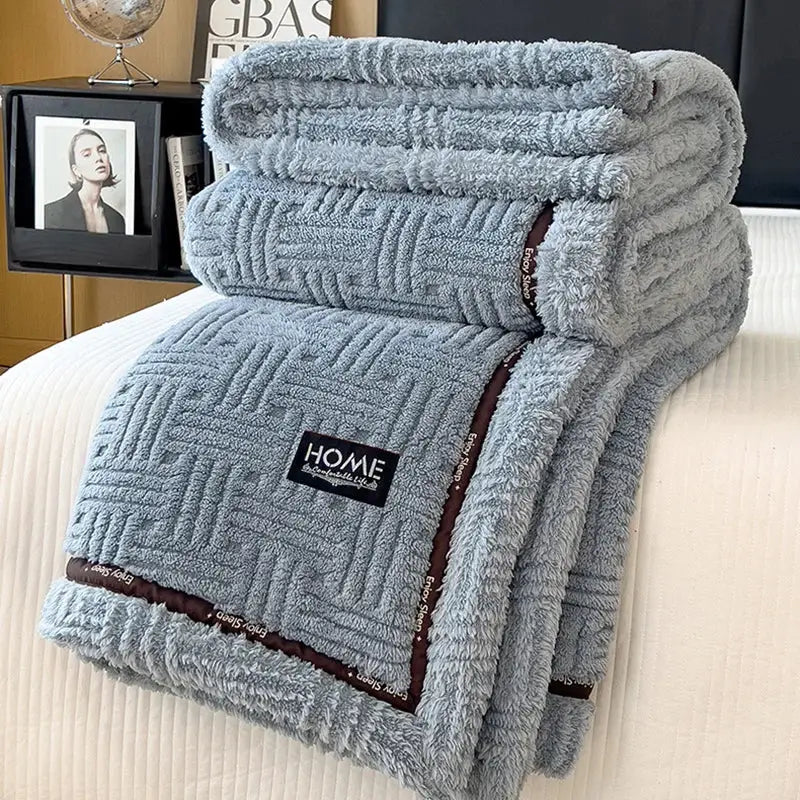 Soft gray luxury coral fleece winter blanket with textured woven pattern and brown trim featuring black home label