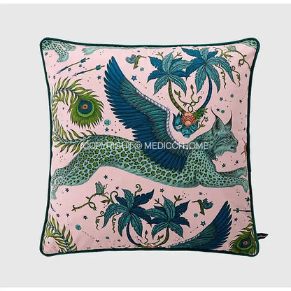 Luxury coral lynx velvet cushion cover in pink with teal mythical creature design featuring palm trees and peacock feathers