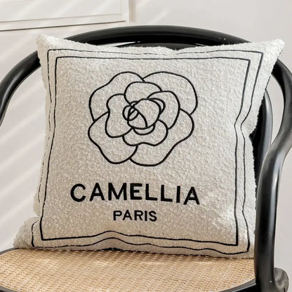 Luxury cream and black decorbites camellia jacquard pillow cover with textured beige fabric and black embroidered flower design