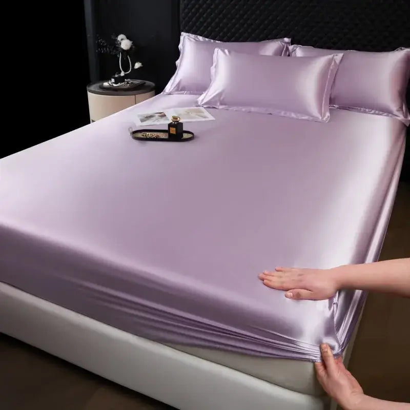 Lavender satin fitted sheet set with matching pillowcases featuring smooth glossy finish and elegant sheen for bedroom use