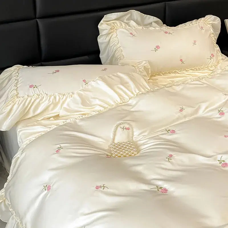 Luxury cream and pink ice silk bedding sets with delicate rose embroidery and ruffled edges by decorbites ice silk