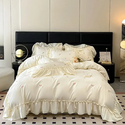 Luxury cream and pink ice silk bedding sets with delicate floral embroidery and soft ruffled edges by Decorbites ice silk