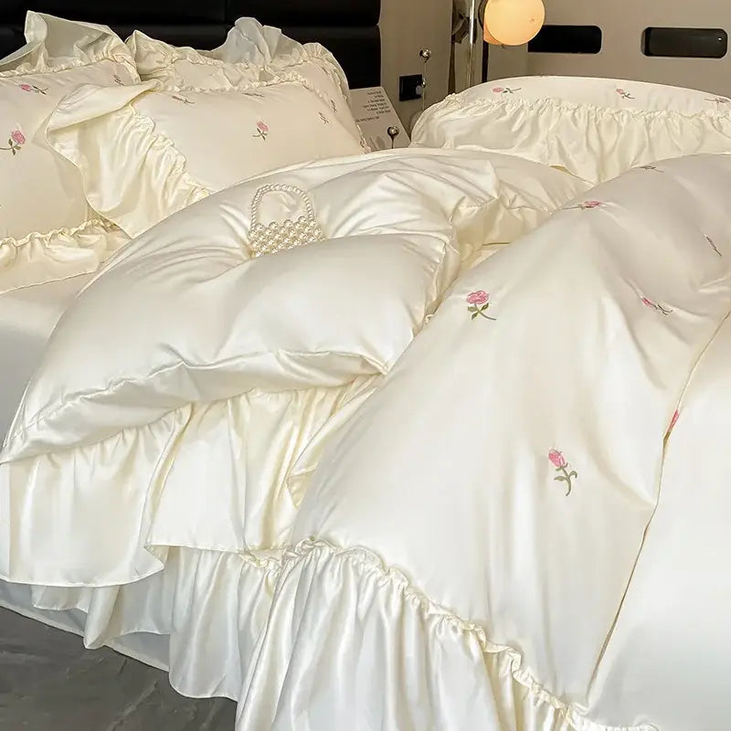 Luxury cream and pink ice silk bedding sets with delicate rose embroidery and ruffled edges by decorbites ice silk