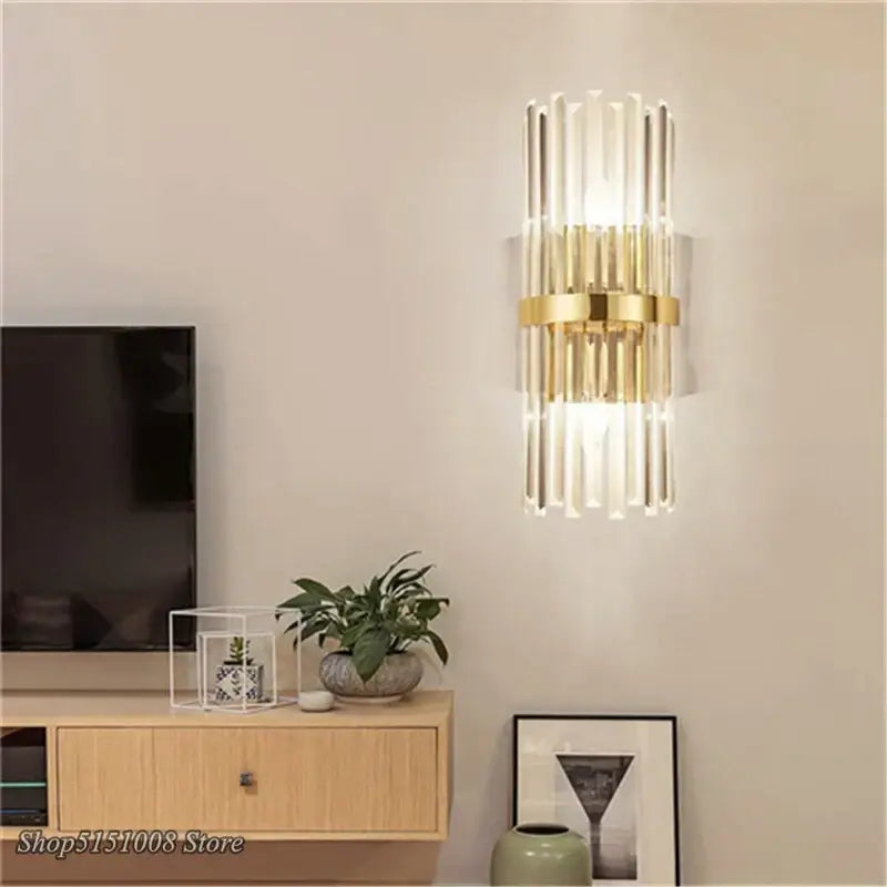 Modern luxury crystal golden wall lamp with vertical crystal rods and gold-toned metal frame for bedroom decorbites crystal golden wall