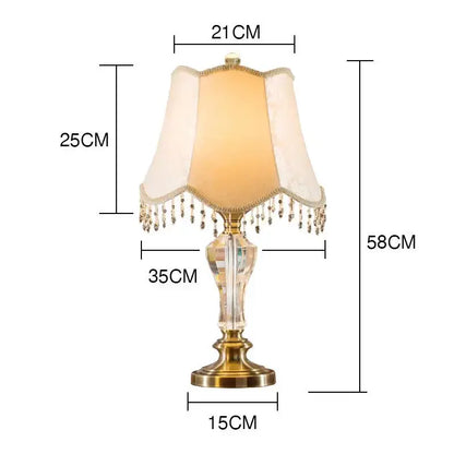 Elegant luxury crystal table lamp with brass base and cream fabric lampshade featuring dangling crystals decorbites crystal table