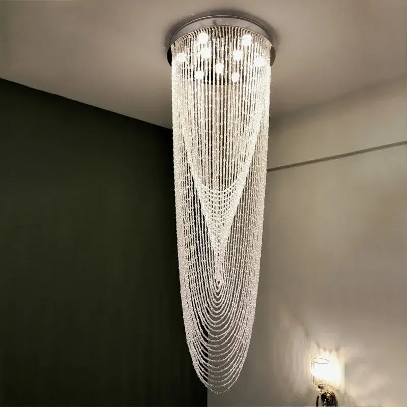 A luxury crystal tassel stair chandelier with cascading clear faceted beads and a sleek metallic base for living room decorbites crystal tassel lighting