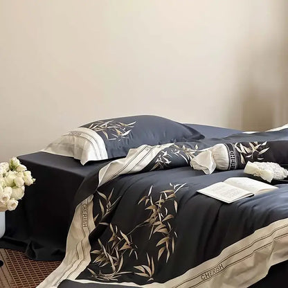 Elegant navy blue satin bedding set with gold bamboo leaf embroidery and cream trim in 1000tc egyptian cotton